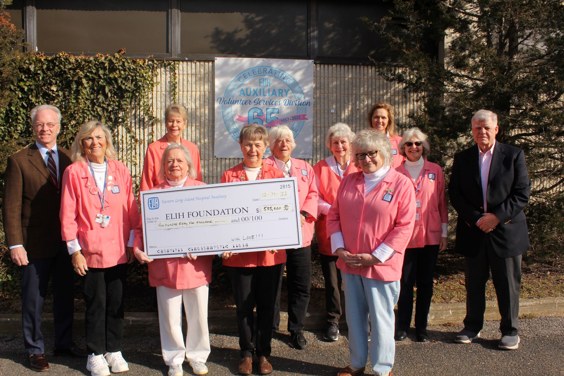 Large group of ELIH Auxiliary members holding a large check
