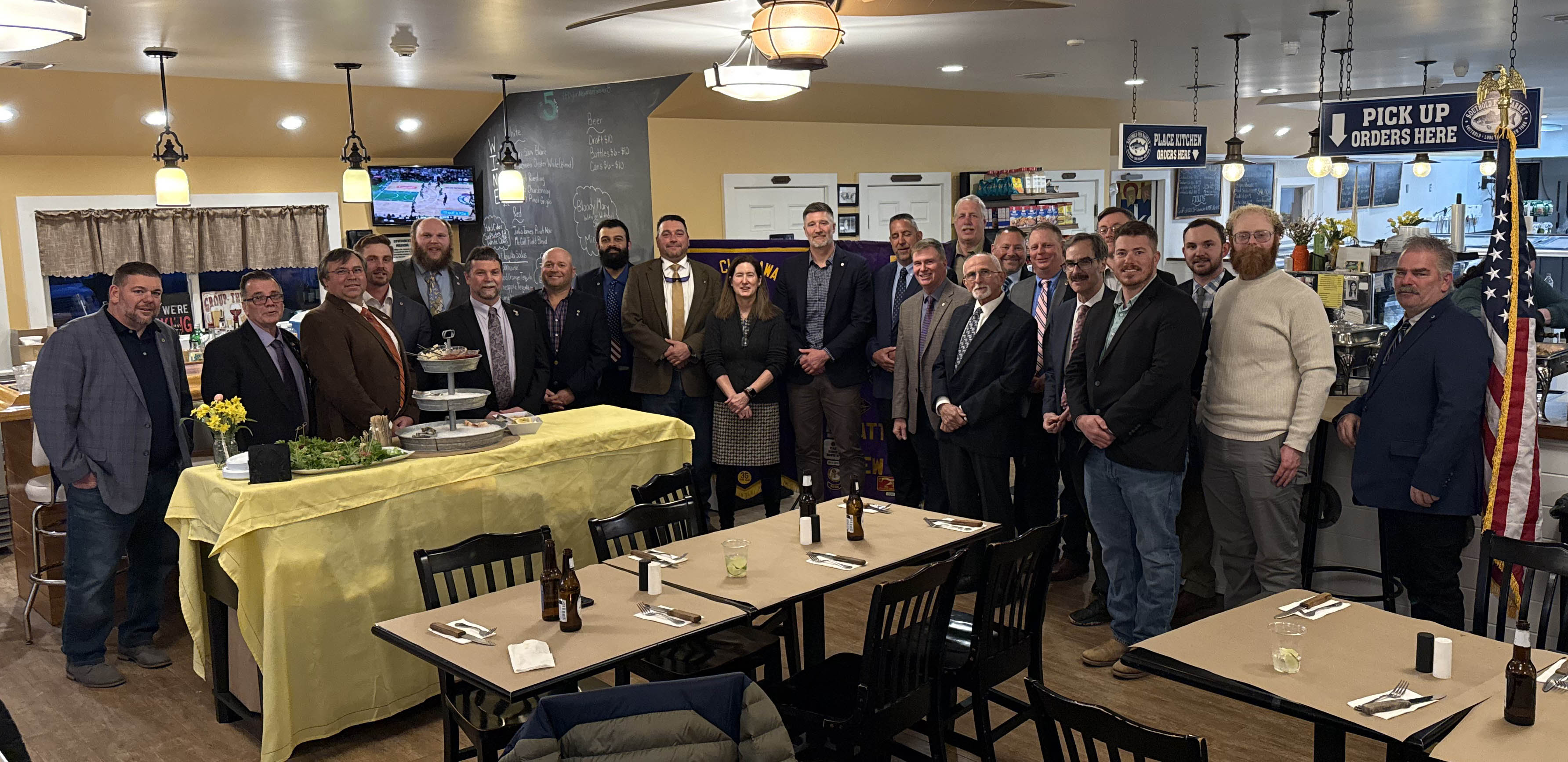 Members of the Mattituck Lion’s Club celebrate the donation to SBELIH at Southold Fish Market.