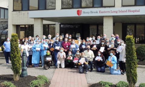 SBELIH staff proudly hold their personalized letters from Greenport and Southold students